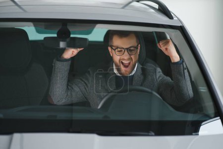 Photo for His true love. Portrait of a mature man smiling happily sitting in a brand new car. - Royalty Free Image
