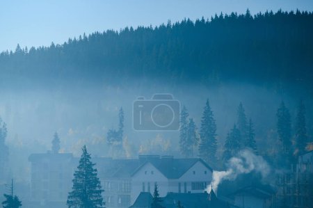 Photo for A close up view on the Alpine chains shrouded in the morning fog, seen from the top of Mittagskogel in Austria. Clear and sunny day. Sharp peaks around. Sun is shining above the high peaks. Serenity. - Royalty Free Image