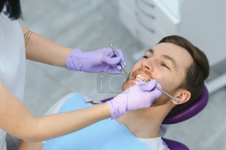 Photo for Dental care concept. Handsome young guy at the dentist's office - Royalty Free Image