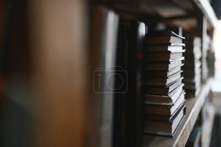 Photo for Old books on shelves in archive blurred image, library. - Royalty Free Image
