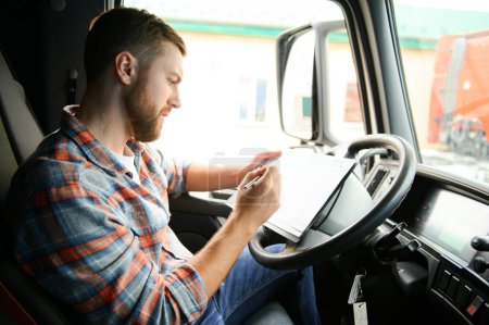 forwarder driver sits behind the wheel of a car and examines waybills documentation for the cargo