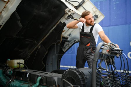 Photo for Man in uniform. Truck repair. Car malfunction. - Royalty Free Image