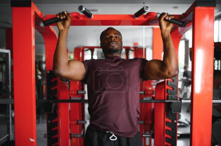 Photo for African American young man doing workout at the gym. - Royalty Free Image