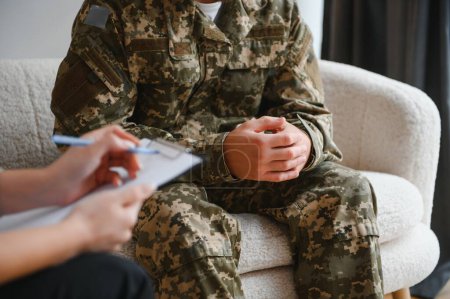 Photo for Cropped shot of soldier and psychiatrist holding hands during therapy session - Royalty Free Image