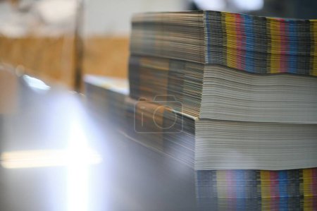 Photo for Paper pile in a finishing, folder station in an offset printer. - Royalty Free Image