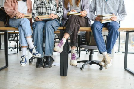 a group of students sitting on a desk.
