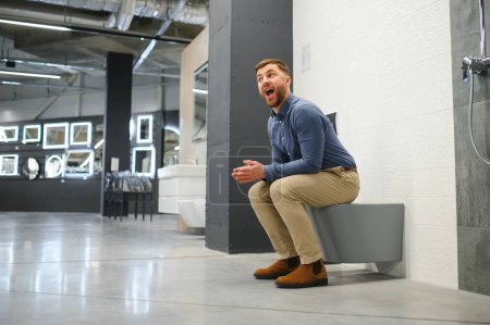 Man sitting on the toilet at the building market.