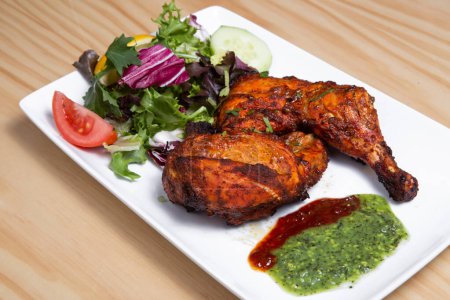 Photo for Tandoori chicken is a dish originating from Indian subcontinent. It is widely popular in South Asia, Middle Eastern and Western countries - Royalty Free Image