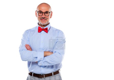 Foto de Close-up of mid aged man wearing shirt and bow tie and standing at isolated grey background. Copy space. - Imagen libre de derechos