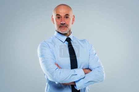 Photo for Studio portrait of mid aged man wearing shirt and tie and standing at isolated background. Confident male looking a camera. Copy space. - Royalty Free Image