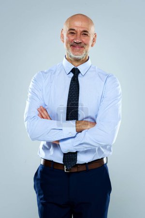 Foto de Foto recortada de un hombre de negocios sonriente parado en un fondo gris aislado. Lleva camisa y corbata. Copiar espacio. - Imagen libre de derechos