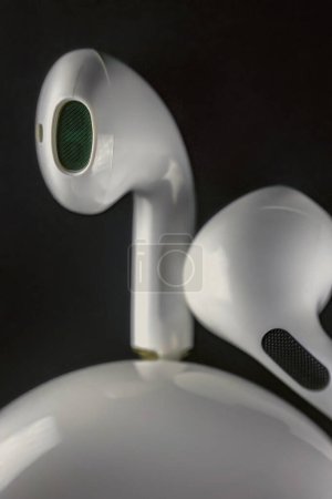 Photo for Small white headphones on a black background - Royalty Free Image