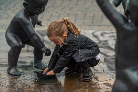 Photo for Little girl playing in the square - Royalty Free Image