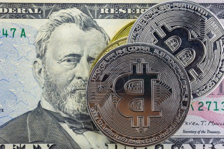 Photo for Bitcoin coins on fifty dollar bill closeup - Royalty Free Image