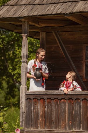 Photo for Mother with daughter and jug in historical clothes - Royalty Free Image
