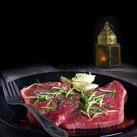 Téléchargez les photos : Filets de steak crus préparés pour la cuisson avec du romarin et du beurre garniture et assaisonnement. Hébergement généreux pour l'espace de copie négatif pour le texte, etc.. - en image libre de droit