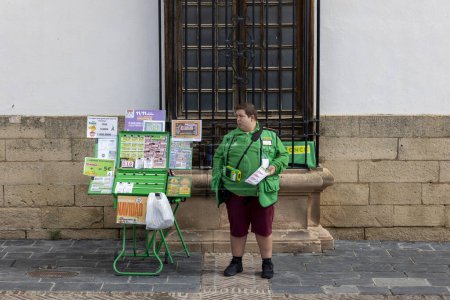 Photo for Ronda, Spain - October 20, 2023: Seller selling scratching lottery tickets on Ronda, Spain. - Royalty Free Image