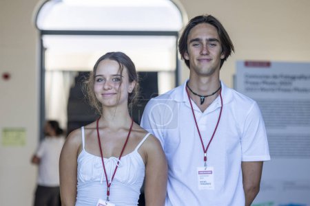 Photo for PORTIMAO, PORTUGAL - 29th JULY 2023: Friendly ushers at the entry of the World Press Photo exhibition event welcoming guest and checking tickets. - Royalty Free Image