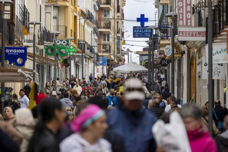 Photo for Ronda, Spain - October 20, 2023: A crowd of many tourists and shoppers, walking on Calle La Bola street in Ronda village, Spain. - Royalty Free Image