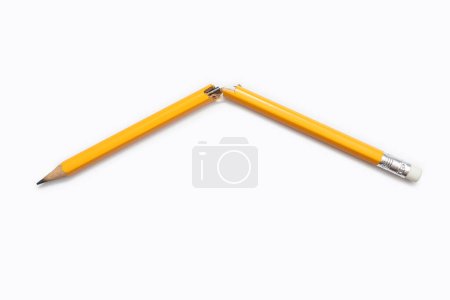 Broken graphite pencil. A yellow pencil broken in the middle on a white background close-up. Free space for text. Emotional stress and aggression caused by studies or work.