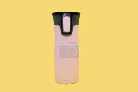Photo for Pink reusable water bottle on a yellow background. Modern pink thermos for tea, coffee or water. Closed travel thermos, travel bottle, beverage container, reusable water bottle. - Royalty Free Image