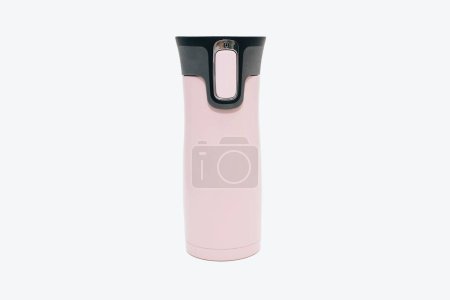 Photo for A pink metal reusable water bottle stands on a white background. Modern thermos for tea, coffee, water. Travel thermos for hot drinks, travel bottle, reusable water bottle. - Royalty Free Image