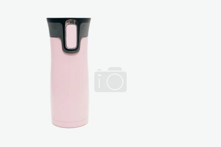 Photo for A pink metal reusable water bottle stands on a white background with free space for text. Modern thermos for tea, coffee, water. Travel thermos for hot drinks, travel bottle, reusable water bottle. - Royalty Free Image