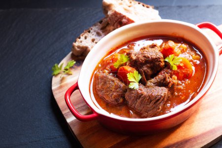 Food concept Homemade Beef stew Goulash on black background with copy space