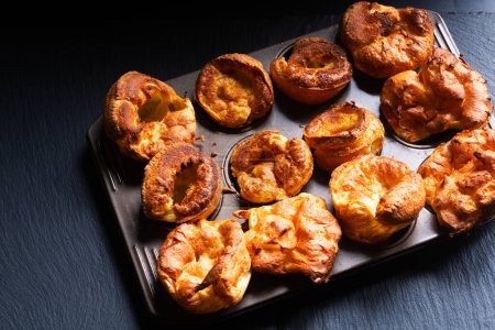 Photo for Food Concept Homemade spot focus Yorkshire pudding on black background with copy space - Royalty Free Image