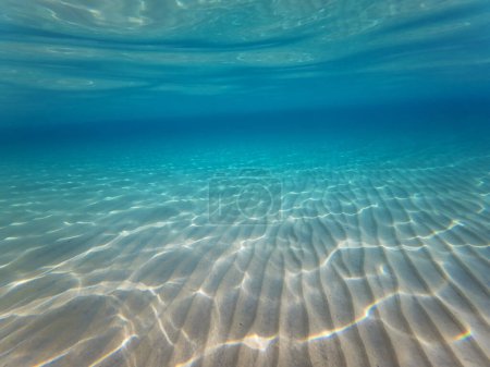 Underwater view of sandy beach with white sand and crystal clear water