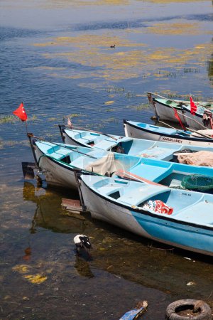 Photo for Wooden fishing boats waiting by Ulubat or Uluabat Lake in Bursa, Turkey, June 25 2023 - Royalty Free Image
