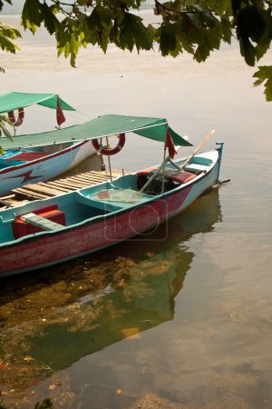 Photo for Wooden fishing boats waiting by Ulubat or Uluabat Lake in Bursa, Turkey, June 25 2023 - Royalty Free Image