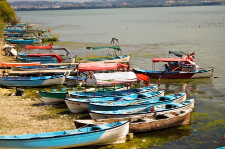 Photo for Wooden fishing boats waiting by Ulubat or Uluabat Lake in Bursa, Turkey, september 08 2020 - Royalty Free Image