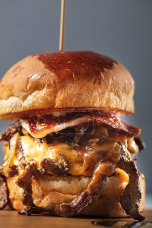 Photo for Double steak burger with smoked bacon, cheddar cheese and bbq sauce. High quality photo - Royalty Free Image
