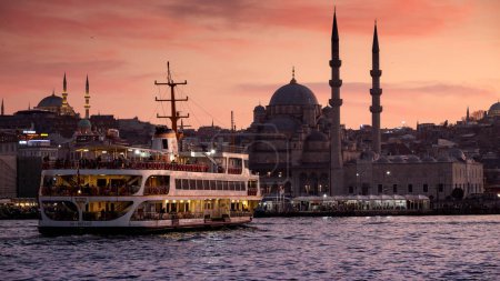 Photo for Famous Istanbul ferry boat going in Bosphorus at sunset against mosques and evening sky. 15th of March, 2023, Turkey, Istanbul - Royalty Free Image