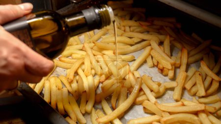 Photo for Closeup of frying french fries potato on baking pan in oven. Fast food, healthy nutrition, cooking in oven - Royalty Free Image