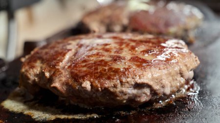 Photo for Closeup shot of juicy burger patties being cooked on electric grill. Cooking at home, kitchen appliance, healthy nutrition, hamburger ingredients - Royalty Free Image