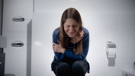 Téléchargez les photos : Triste femme pleurant dans les toilettes et se sentant seule. Concept de dépression, violence familiale, suicide, stress, solitude et frustration - en image libre de droit