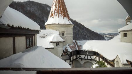 Photo for View from the windows on high towers and roof tops at ancient castle covered with snow. - Royalty Free Image