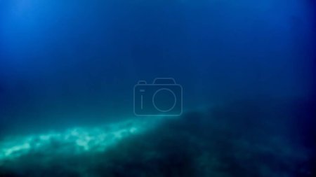 Photo for Abstract blurred underwater shot of sea bottom and sun rays shining through water surface - Royalty Free Image