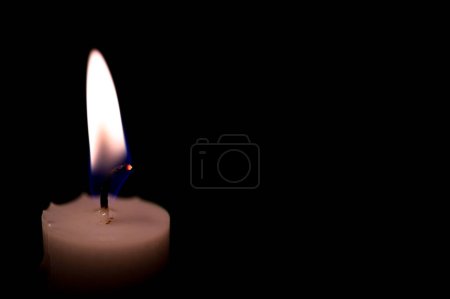 Photo for One burning candle in dark black room Kumla Sweden january 2023 - Royalty Free Image