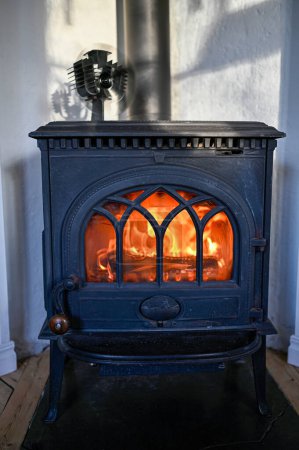 Photo for Orange fire in old cast iron stove Kumla Sweden january 27 2023 - Royalty Free Image