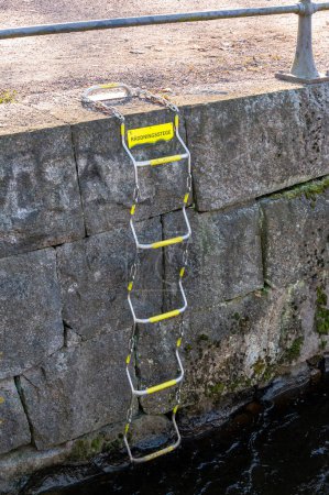 Ladder up from river in Orebro Sweden with text in Swedish meaning rescue ladder March 7 2024