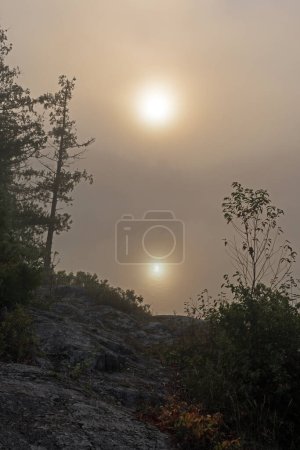 Téléchargez les photos : Réflexion du soleil tôt le matin Brouillard sur le lac Jenny dans la région des eaux limitrophes Canot dans le Minnesota - en image libre de droit