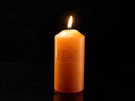 Foto de One light candle burning brightly on black background, closeup - Imagen libre de derechos