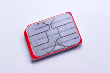 Photo for Person inserting a sim card into back of mobile phone, Sim card in tray being inserted into phone, closeup - Royalty Free Image