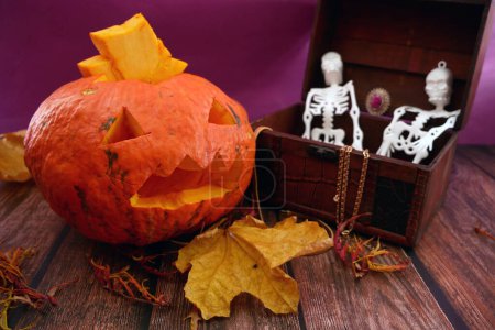 Foto de Esqueletos de Halloween en el pecho de madera con tesoros ocultos, murciélagos y calabaza Jack O Lantern. Tarjeta de felicitación de Halloween, invitación a la fiesta de Halloween, el día de los Muertos, primer plano - Imagen libre de derechos