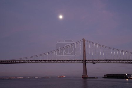 Photo for Moonrise over Oakland bay bridge California. High quality photo taken at blue hour - Royalty Free Image