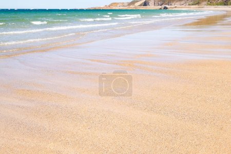 Photo for Large sandy beach in the town of "Sables d'or les pins" in Brittany at low tide in summer. - Royalty Free Image