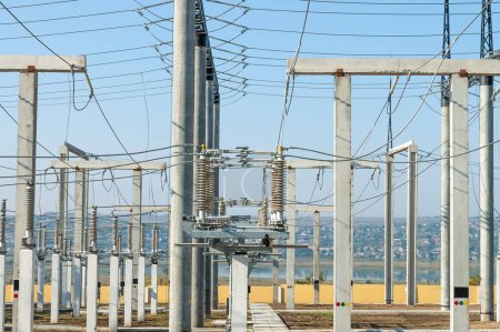 Foto de Part of high-voltage substation on blue sky background with switches and disconnectors. Ukrainian energy infrastructure. - Imagen libre de derechos